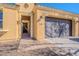 Front view of a Spanish style home with a two car garage at 1572 E Artemis Trl, Queen Creek, AZ 85140