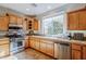 Modern kitchen with stainless steel appliances and oak cabinets at 1572 E Artemis Trl, Queen Creek, AZ 85140