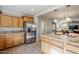 Island kitchen features stainless steel appliances and oak cabinets at 1572 E Artemis Trl, Queen Creek, AZ 85140