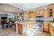 Kitchen features stainless steel appliances and light wood cabinets at 1572 E Artemis Trl, Queen Creek, AZ 85140