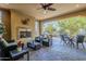 Relaxing covered patio with fireplace and seating area at 1572 E Artemis Trl, Queen Creek, AZ 85140