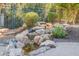 Landscaped backyard with a serene water feature at 1572 E Artemis Trl, Queen Creek, AZ 85140