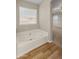 Relaxing bathroom with a large bathtub and light flooring at 16000 W Sherman St, Goodyear, AZ 85338