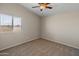 Bedroom with carpet flooring, window, and ceiling fan at 16000 W Sherman St, Goodyear, AZ 85338