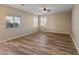 Large living room with wood-look floors and neutral walls at 16000 W Sherman St, Goodyear, AZ 85338