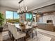 Bright dining room with a large table, access to the patio, and modern chandelier at 18022 E Vista Desierto --, Rio Verde, AZ 85263