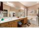 Double vanity bathroom with soaking tub and mosaic accents at 18877 N 59Th Dr, Glendale, AZ 85308