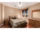 Bedroom with wood floors, ceiling fan, and built-in dresser at 18877 N 59Th Dr, Glendale, AZ 85308