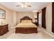 Main bedroom with large wood bed frame and ceiling fan at 18877 N 59Th Dr, Glendale, AZ 85308