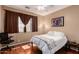 Bedroom with window, ceiling fan, and wood floors at 18877 N 59Th Dr, Glendale, AZ 85308