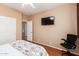 Bright bedroom with wood floors, and a view of the bathroom at 18877 N 59Th Dr, Glendale, AZ 85308