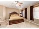 Main bedroom with large wood bed frame and ceiling fan at 18877 N 59Th Dr, Glendale, AZ 85308