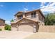 Two-story house with a three-car garage and desert landscaping at 18877 N 59Th Dr, Glendale, AZ 85308