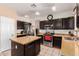 Kitchen with dark cabinets, stainless steel appliances and an island at 18877 N 59Th Dr, Glendale, AZ 85308