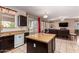 Kitchen with island, dark cabinets, and view to Gathering room at 18877 N 59Th Dr, Glendale, AZ 85308