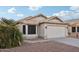 Tan house with tile roof, two-car garage, and landscaped yard at 20947 N 107Th Dr, Peoria, AZ 85373