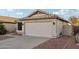 Tan house with tile roof, two-car garage, and landscaped yard at 20947 N 107Th Dr, Peoria, AZ 85373