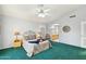 Main bedroom with a plush carpet, ceiling fan and ensuite bathroom at 20947 N 107Th Dr, Peoria, AZ 85373