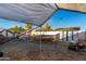 Backyard featuring sheds, a trampoline, and desert landscaping at 21063 N 33Rd Ln, Phoenix, AZ 85027