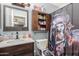 Bathroom featuring a sink and cabinet, toilet, shower curtain and shelf at 21063 N 33Rd Ln, Phoenix, AZ 85027