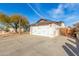 View of a two-car garage with a wooden gate nearby the structure at 21063 N 33Rd Ln, Phoenix, AZ 85027