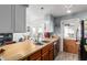 Open concept kitchen with tile flooring, a stainless steel sink, and wood countertops at 21063 N 33Rd Ln, Phoenix, AZ 85027