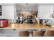 Bright kitchen showcasing wooden countertops, stainless steel sink, and a breakfast bar at 21063 N 33Rd Ln, Phoenix, AZ 85027