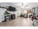 Bright living room with light blue walls, tile flooring, and large wall-mounted TV at 21063 N 33Rd Ln, Phoenix, AZ 85027