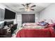 Main bedroom featuring ceiling fan, TV, desk, and wood floors at 21063 N 33Rd Ln, Phoenix, AZ 85027