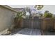 Landscaped backyard with a gray gate and detached garage at 2115 W Harwell Rd, Phoenix, AZ 85041