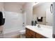 Main bathroom with tub, shower, and wood vanity at 2115 W Harwell Rd, Phoenix, AZ 85041