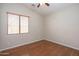 Simple bedroom with wood floors and ceiling fan at 2115 W Harwell Rd, Phoenix, AZ 85041