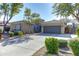 Single-story home with a two-car garage and landscaped yard at 2115 W Harwell Rd, Phoenix, AZ 85041