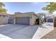 Two-car garage with driveway and landscaping at 2115 W Harwell Rd, Phoenix, AZ 85041