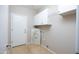 Laundry room with cabinets and overhead storage at 2115 W Harwell Rd, Phoenix, AZ 85041