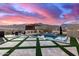 Stunning sunset view over a backyard pool and patio area at 21632 W Hillcrest Blvd, Buckeye, AZ 85396