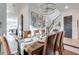 Spacious dining room with a wooden table, chandelier, and view into the kitchen at 21632 W Hillcrest Blvd, Buckeye, AZ 85396