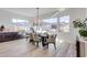 Modern dining room with a large table, chandelier, and mountain views at 21632 W Hillcrest Blvd, Buckeye, AZ 85396