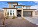 Two-story home with modern design, stone accents, and a three-car garage at 21632 W Hillcrest Blvd, Buckeye, AZ 85396