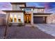 Two-story home with modern design, stone accents, and a three-car garage at 21632 W Hillcrest Blvd, Buckeye, AZ 85396