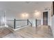 Bright hallway with light wood flooring and modern railing at 21632 W Hillcrest Blvd, Buckeye, AZ 85396