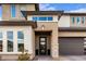 Modern front entrance with a sleek black door and stone accents at 21632 W Hillcrest Blvd, Buckeye, AZ 85396