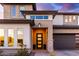 Modern front entrance with a sleek black door and stone accents at 21632 W Hillcrest Blvd, Buckeye, AZ 85396