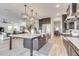 Modern kitchen with a large island, stainless steel appliances, and dark cabinetry at 21632 W Hillcrest Blvd, Buckeye, AZ 85396