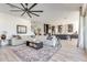 Open living room with sectional sofa and view of the kitchen at 21632 W Hillcrest Blvd, Buckeye, AZ 85396