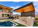 Modern outdoor kitchen with built-in appliances and wood ceiling at 21632 W Hillcrest Blvd, Buckeye, AZ 85396