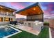 Modern outdoor kitchen with built-in appliances and wood ceiling at 21632 W Hillcrest Blvd, Buckeye, AZ 85396