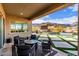 Covered patio with mountain views and seating area overlooking pool at 21632 W Hillcrest Blvd, Buckeye, AZ 85396