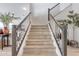 Modern staircase with sleek dark wood railings and light wood steps at 21632 W Hillcrest Blvd, Buckeye, AZ 85396