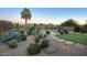 Landscaped backyard with putting green, desert plants, and a relaxing patio area at 23861 N 74Th Pl, Scottsdale, AZ 85255